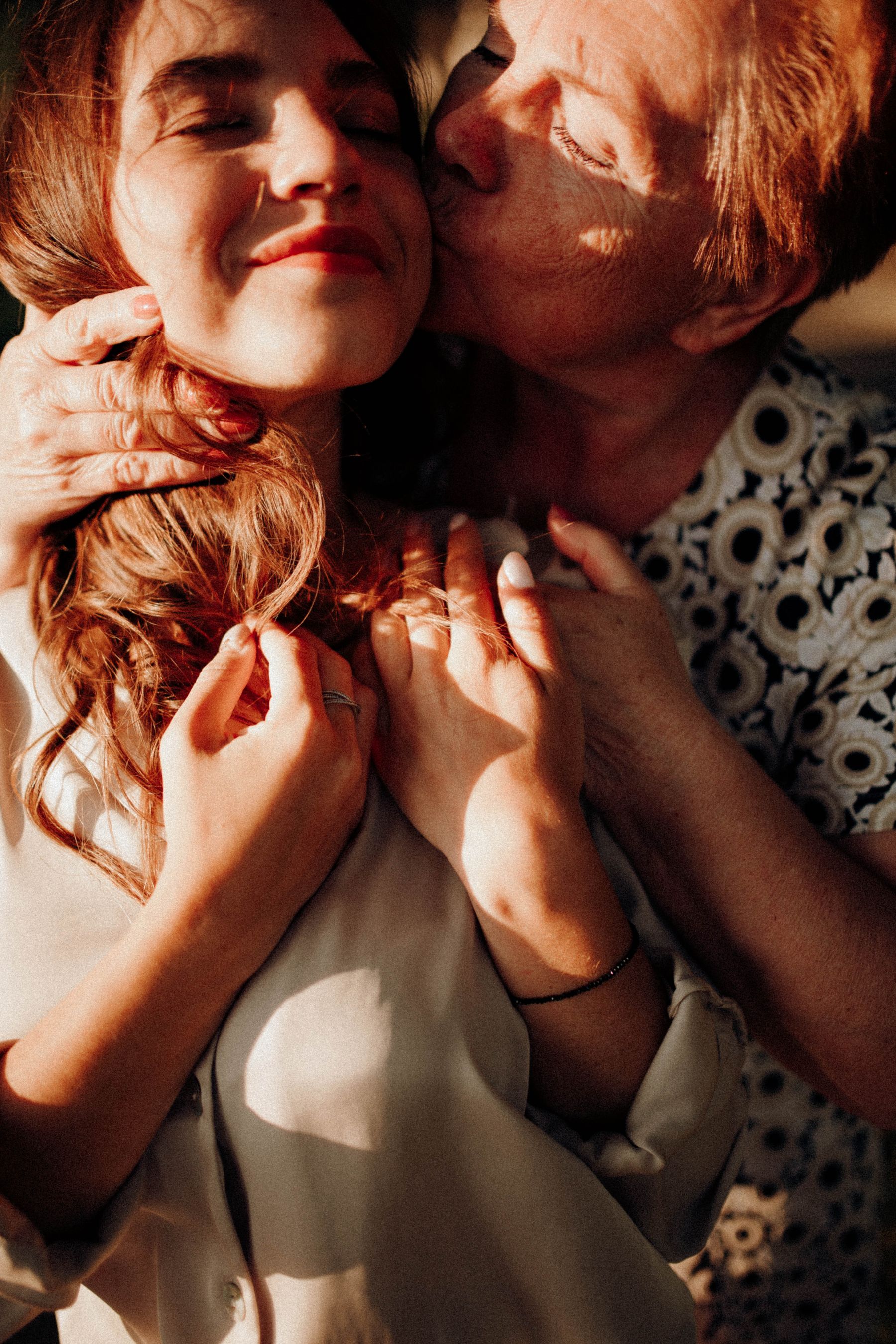 A senior woman sharing a warm moment with her adult daughter